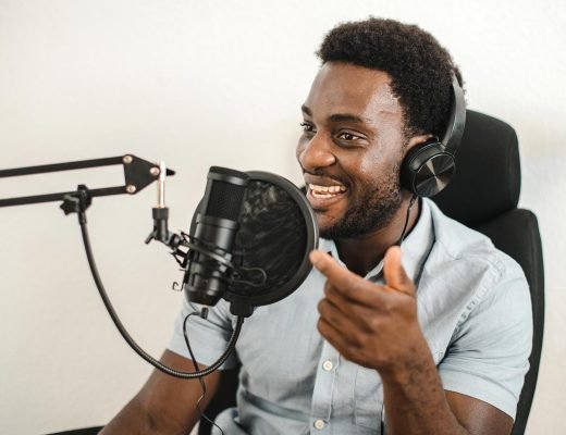 delighted-black-man-recording-podcast-and-talking-2022-09-30-16-39-57-utc