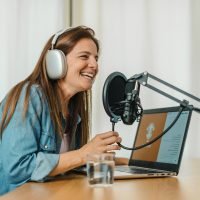 happy-woman-recording-podcast-and-speaking-in-mic-2022-09-30-16-39-52-utc
